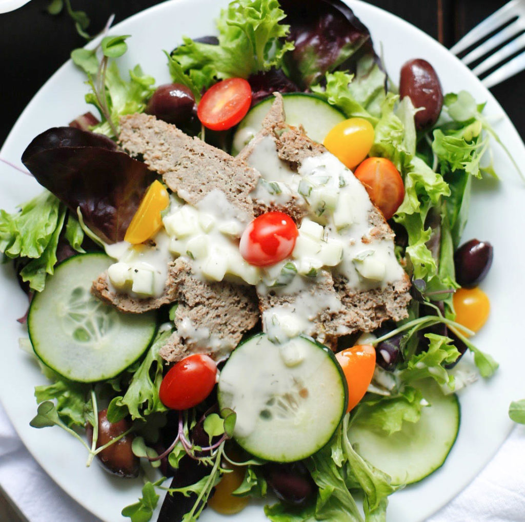 Green salad with lamb gyro meat and tzatziki sauce