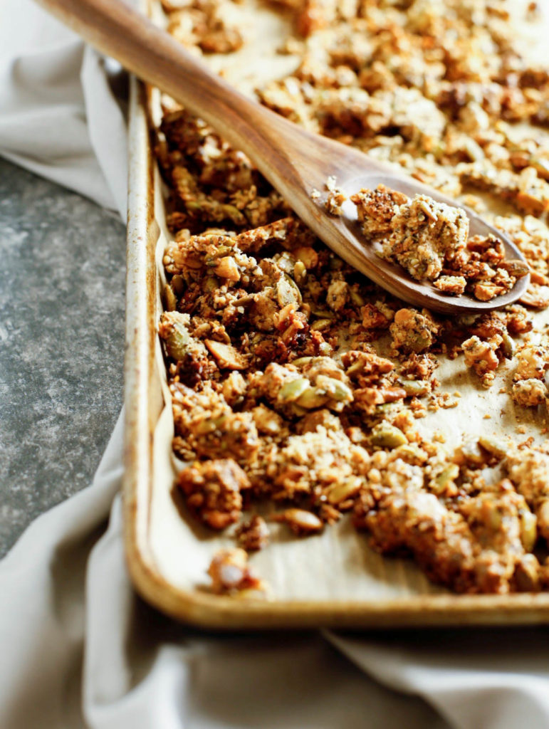 Grain-free granola on a baking sheet with a spoon 