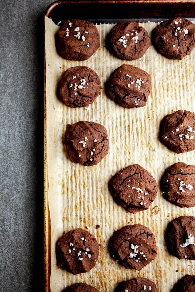 Chocolate cookies with sea salt freshly baked on a baking tray