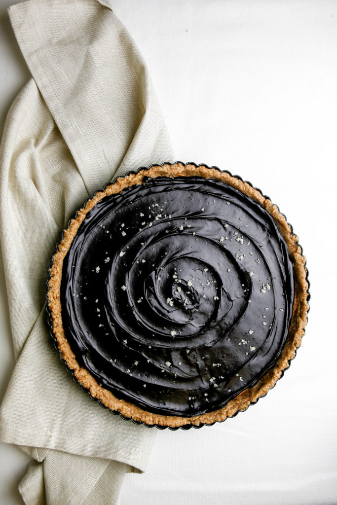 No bake chocolate almond butter tart with a napkin