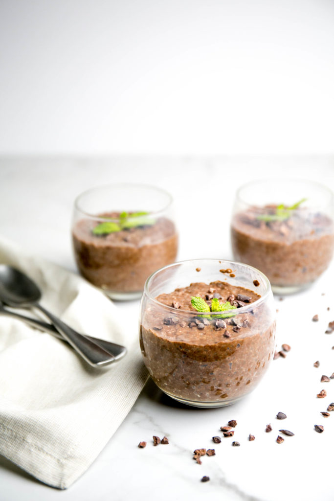 Chia seed pudding in glasses with spoons and napkin