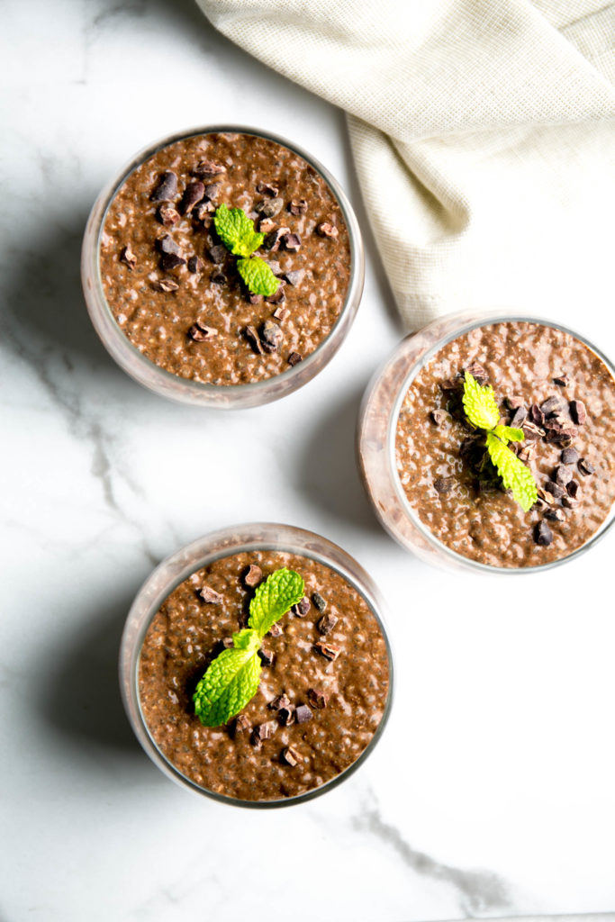 Three glasses of chocolate chia seed pudding with mint