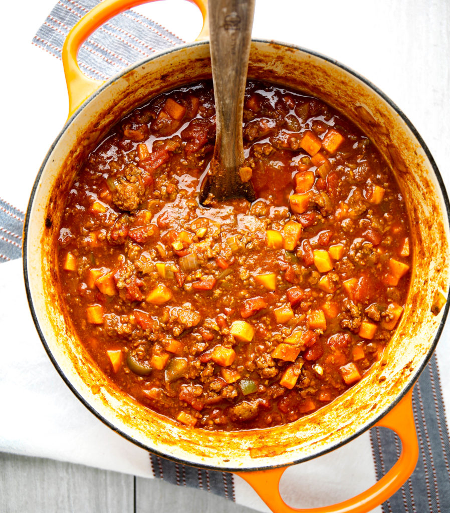 Aerial view of sweet potato chili in pot with wooden spoon 