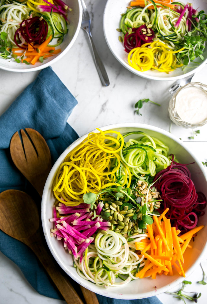Rainbow winter salad with two servings on salad plates