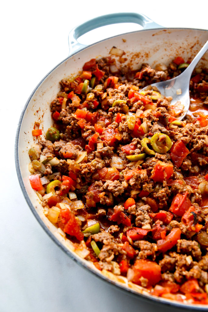 beef picadillo with serving spoon