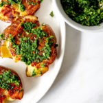 smashed potatoes on a plate with Gremolata sauce