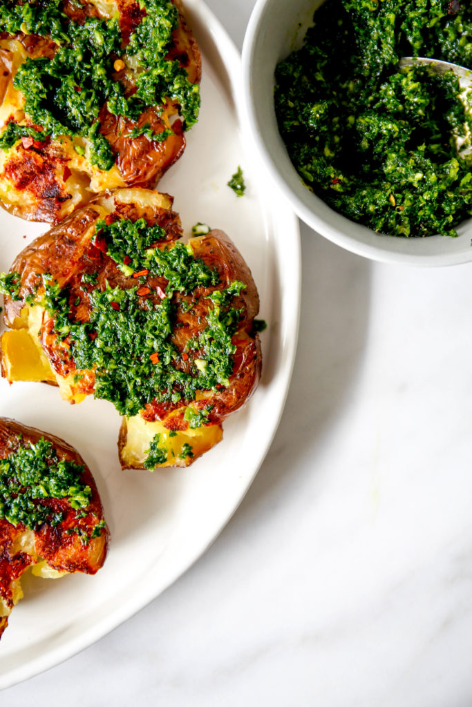 smashed potatoes on a plate with Gremolata sauce