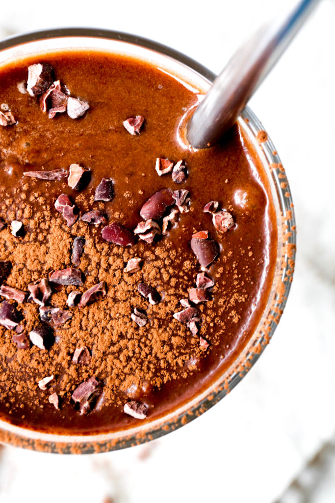 aerial view of a coffee smoothie with cacao powder and cacao nibs