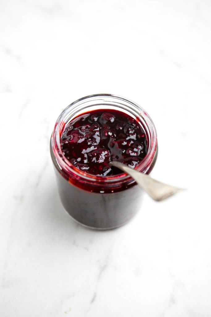 blackberry lemon jam in a glass jar with a spoon