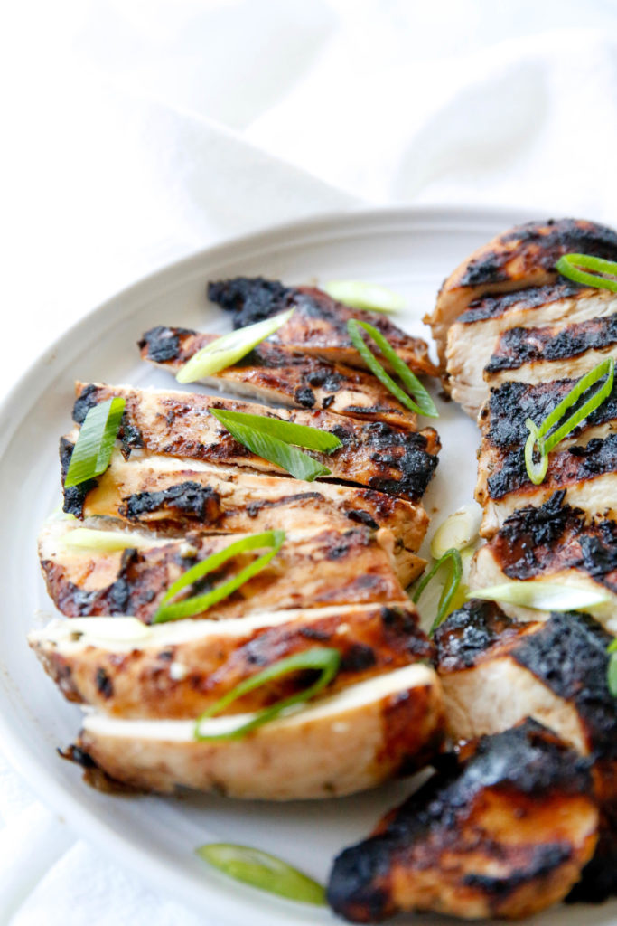 sliced grilled chicken with chopped scallions on top