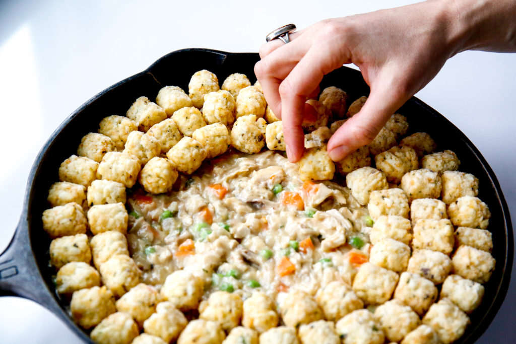 topping a chicken pot pie with frozen tater tots