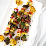 Beef Skewers with peppers and onions on a platter