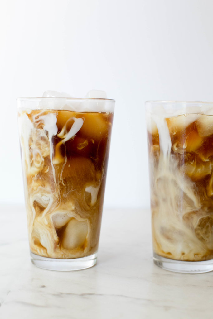 Two glasses of iced 'mocha' with coconut milk swirling