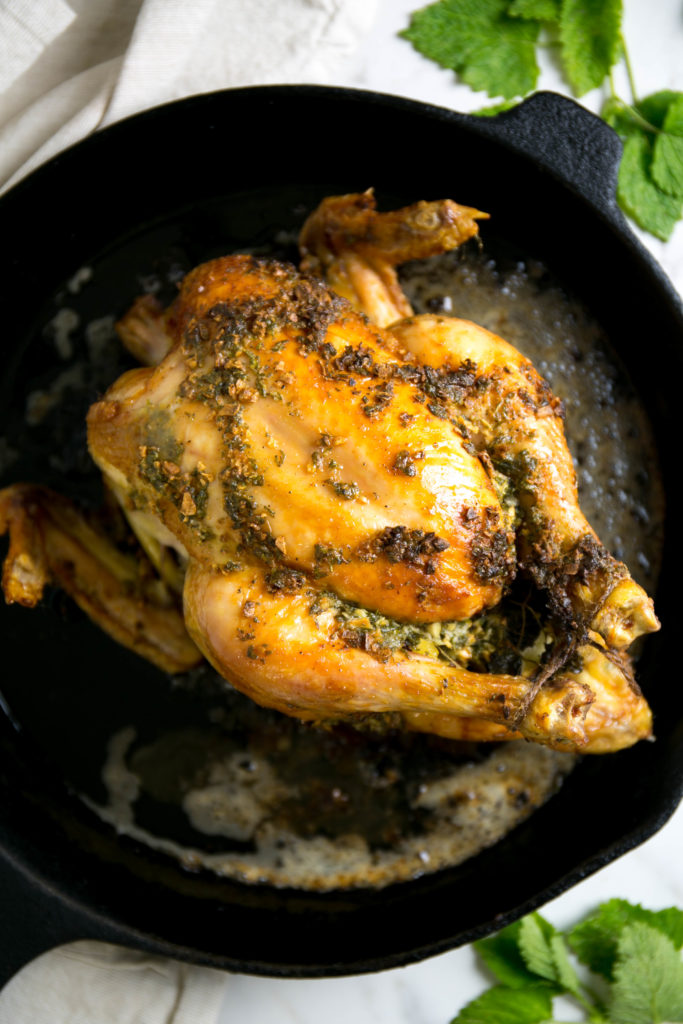 lemon balm roasted chicken freshly cooked on a cast iron skillet