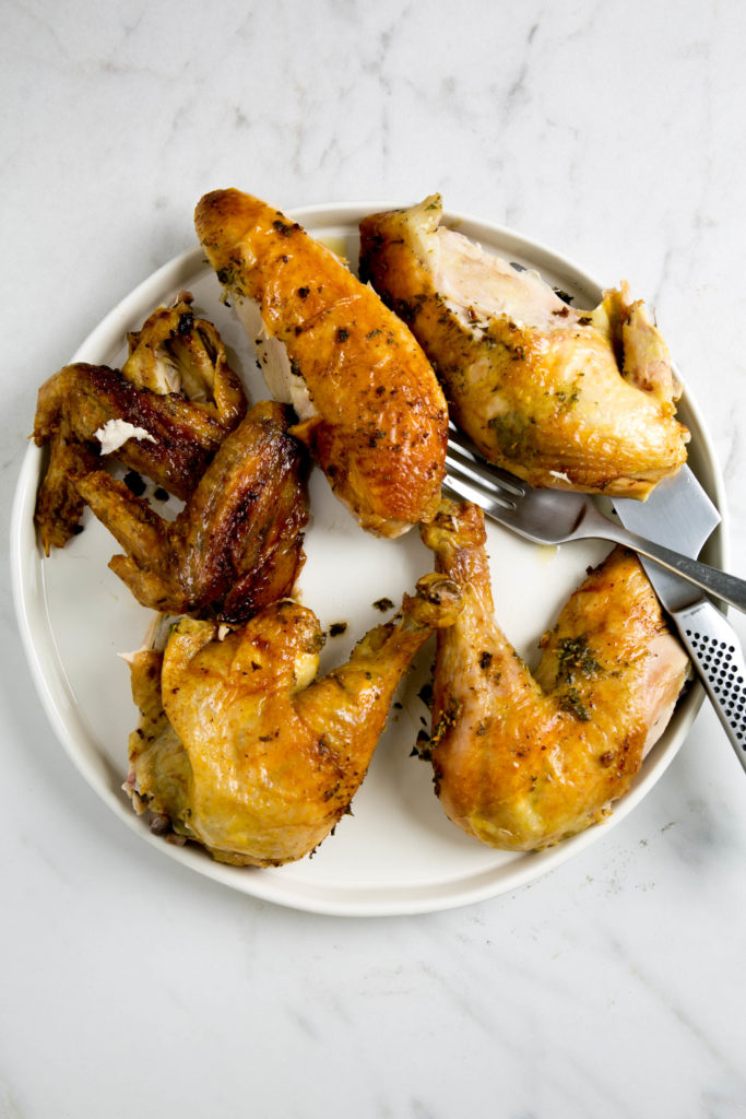 Chicken breasts, thighs and wings with a knife and form on a platter