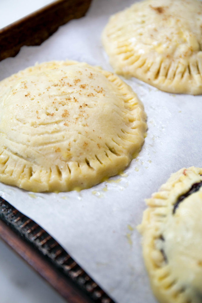 unbaked cherry hand pies with coconut sugar on top