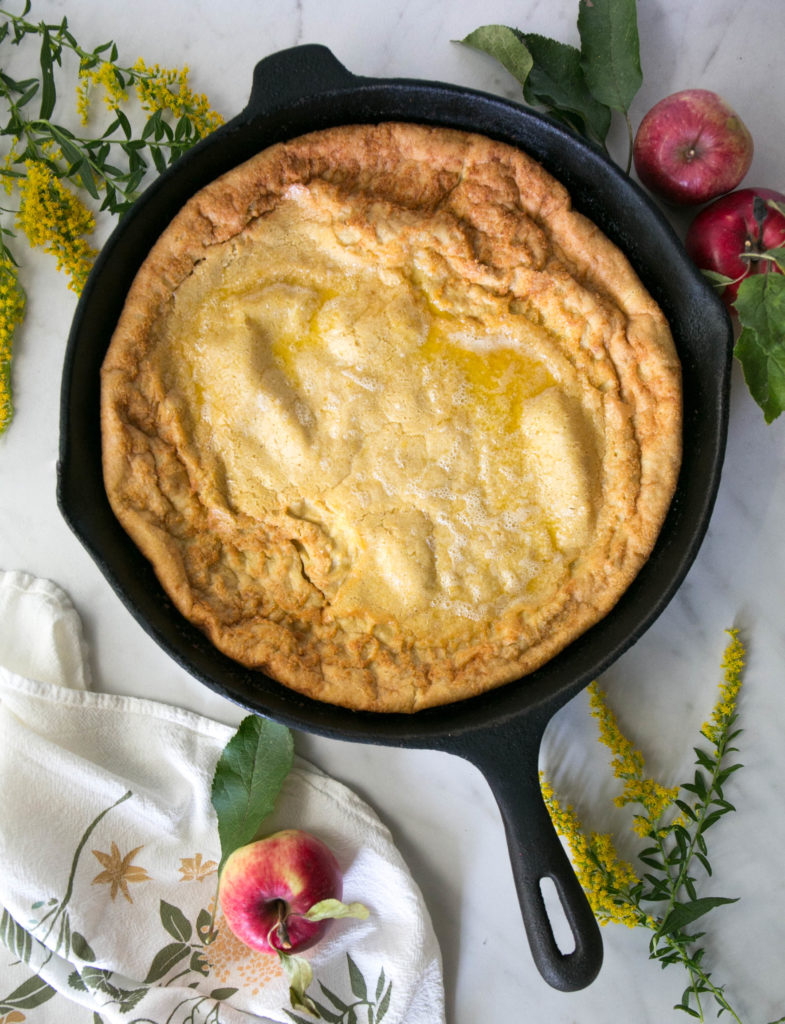 Dutch baby with apples, flowers and a napkin