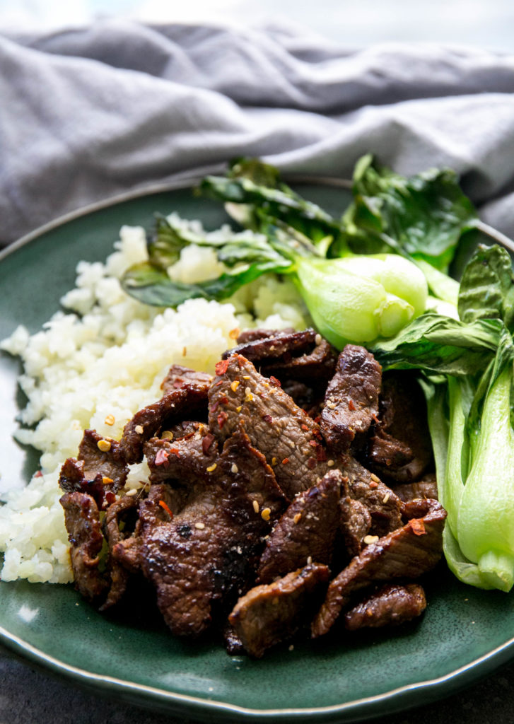 Unclose picture of thinly sliced beef bulgogi with cauliflower rice and baby boy choy