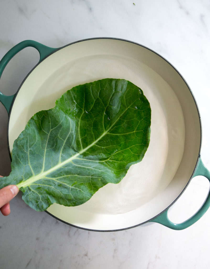 collard green leaf being blanched in hot water