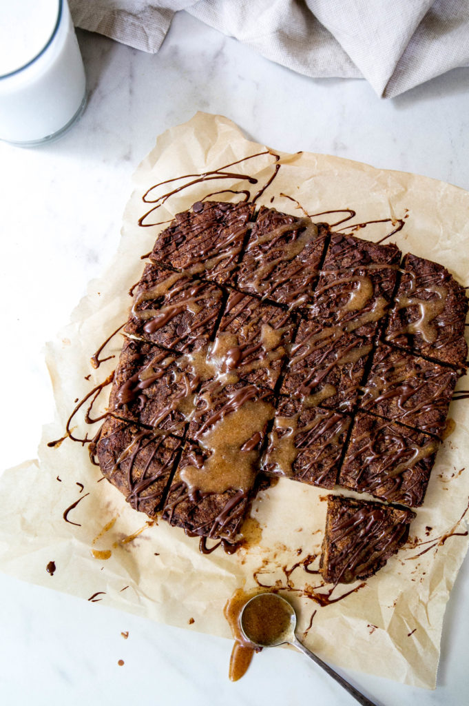 Blondies with a glass of milk and a chocolate drizzle