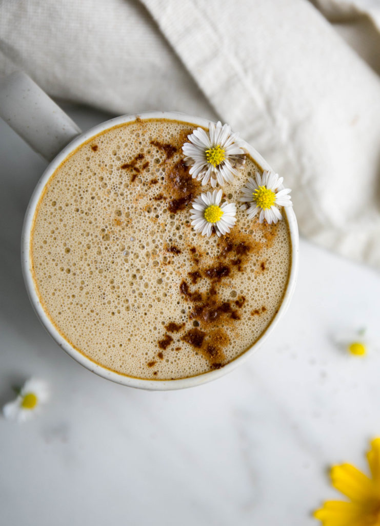 Frothy chai latte with cinnamon and aster flowers