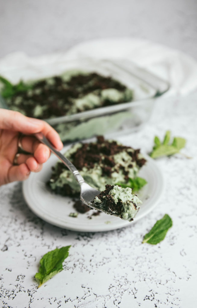 a fork full of creamy grasshopper pie on a plate