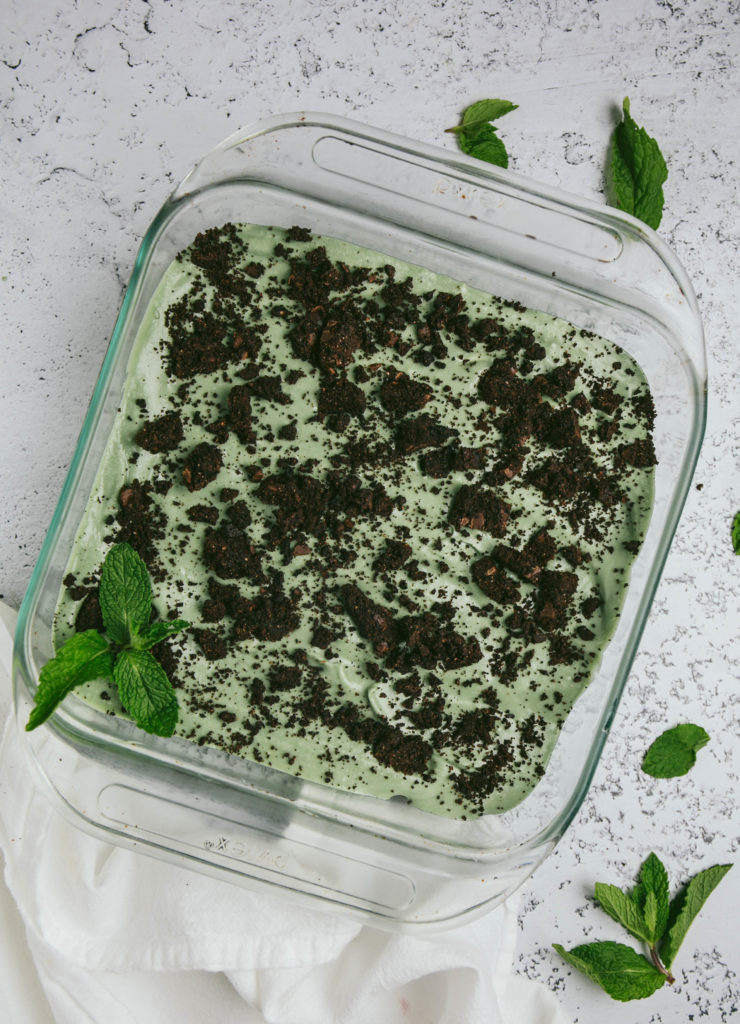 Aerial view of grasshopper pie with mint leaves and white napkin