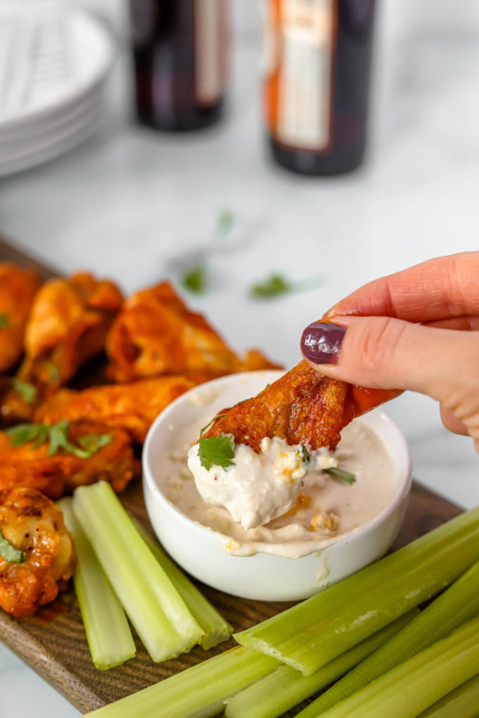 Air Fryer Buffalo Wings from Honest Grub, Honest Foodie being dipped into ranch with celery