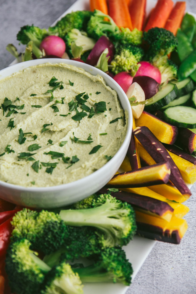 French Onion Dip on a platter with an assortment of fresh vegetables