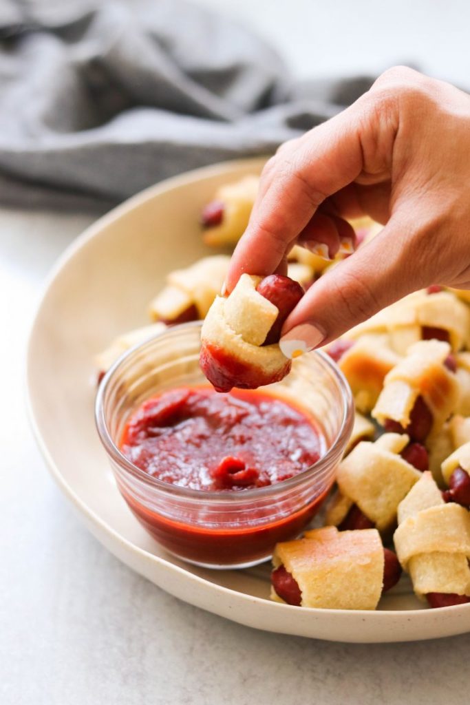 Paleo Pigs in a Blanket from What Great Grandma Ate being dipped into ketchup