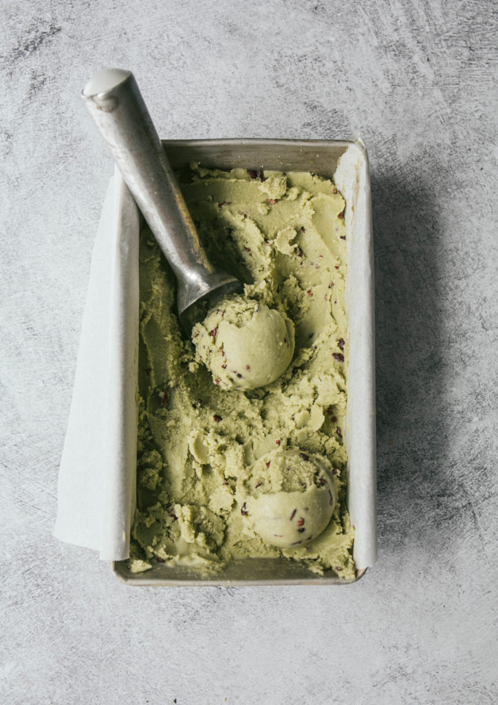 Aerial view of mint chocolate chip ice cream in a pan with ice cream scooper