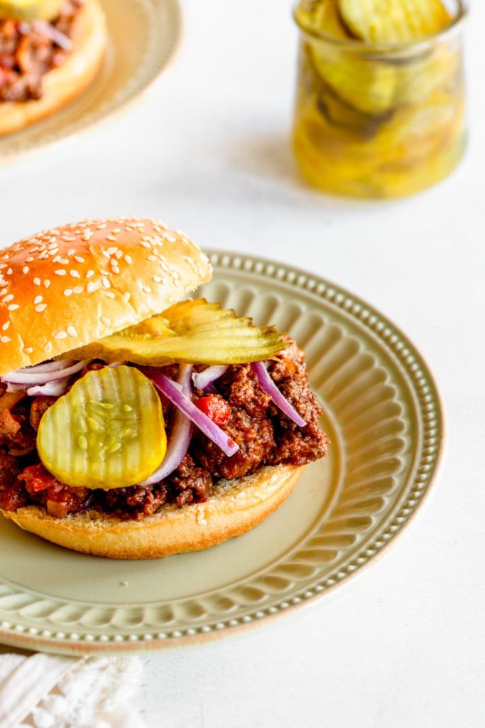 Sloppy Joes on a plate with pickles