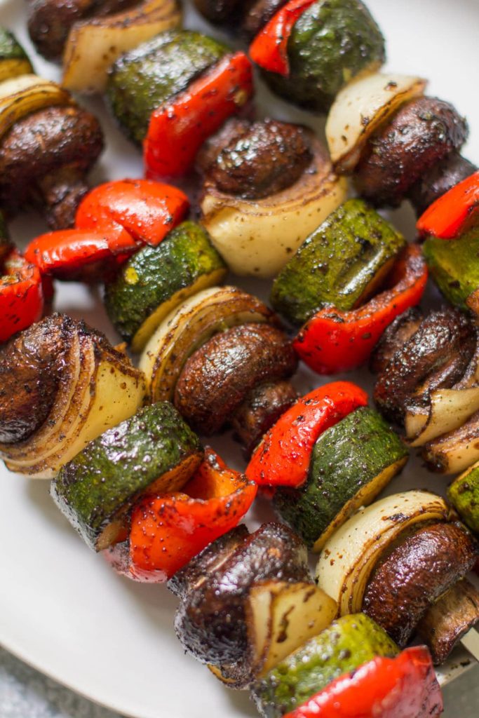 Vegetable kebabs with onions, zucchini and peppers on a platter