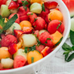 Watermelon Strawberry Salad in a white bowl with linen
