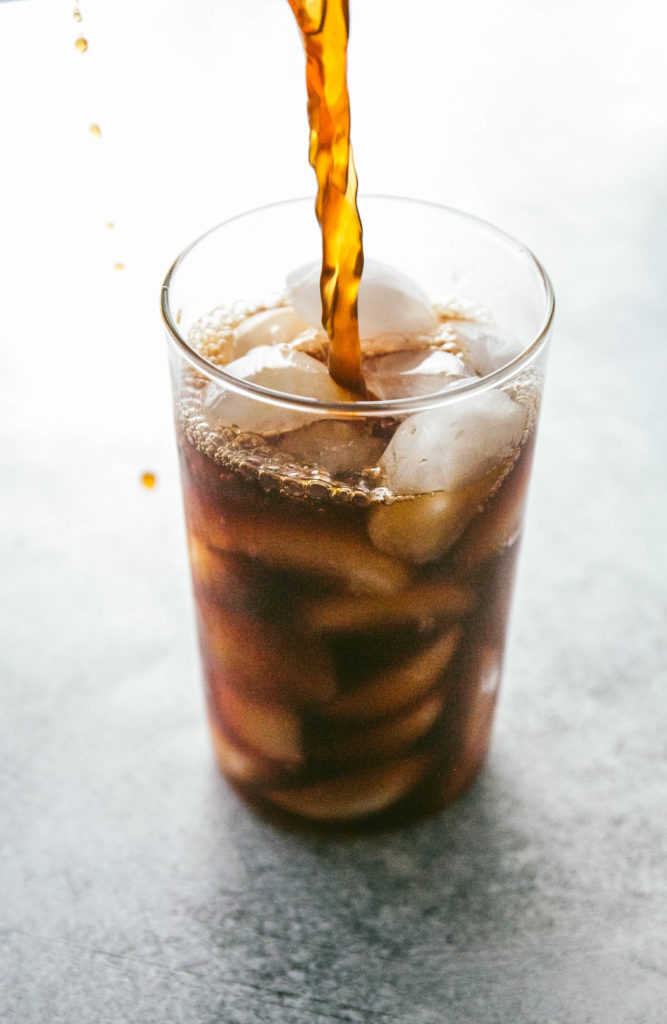 Cold brew coffee being poured into a glass