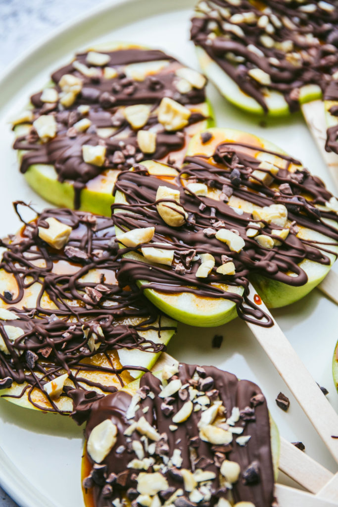 Caramel apple lollipops with chocolate and chopped cashews