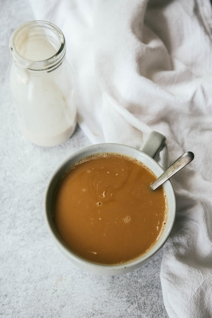 Vanilla coffee creamer with cup of coffee
