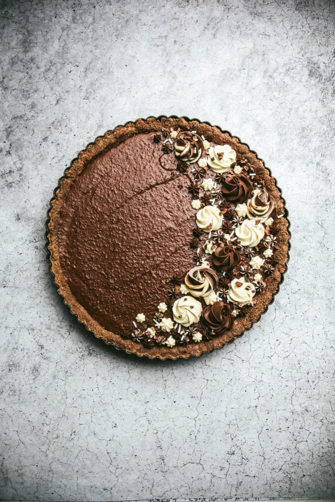 Aerial view of a chocolate cappuccino tart with frosting decorations