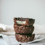 Side view of no-bake grasshopper pie cups stacked on top of eachother