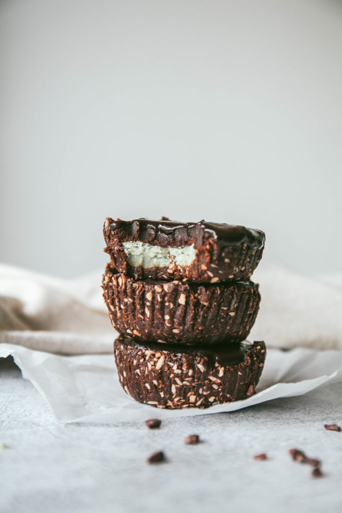 Side view of no-bake grasshopper pie cups stacked on top of eachother