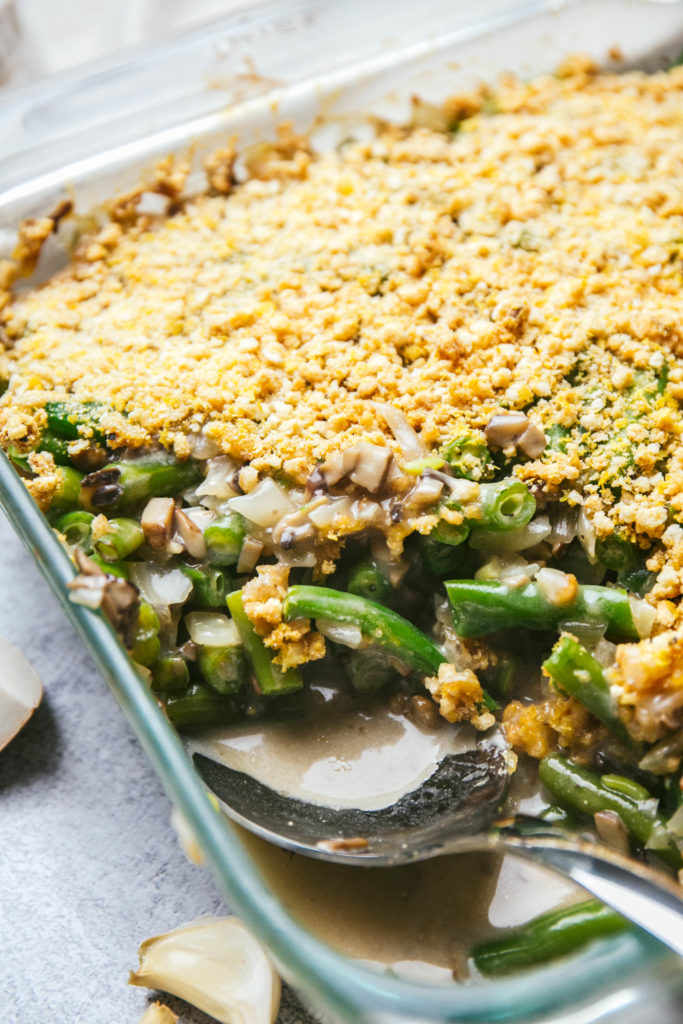 Dairy-free green bean casserole with a serving spoon