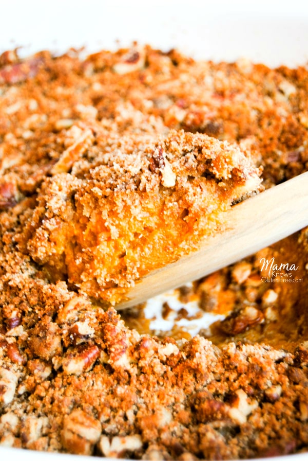 Paleo sweet potato casserole being scooped out a casserole dish