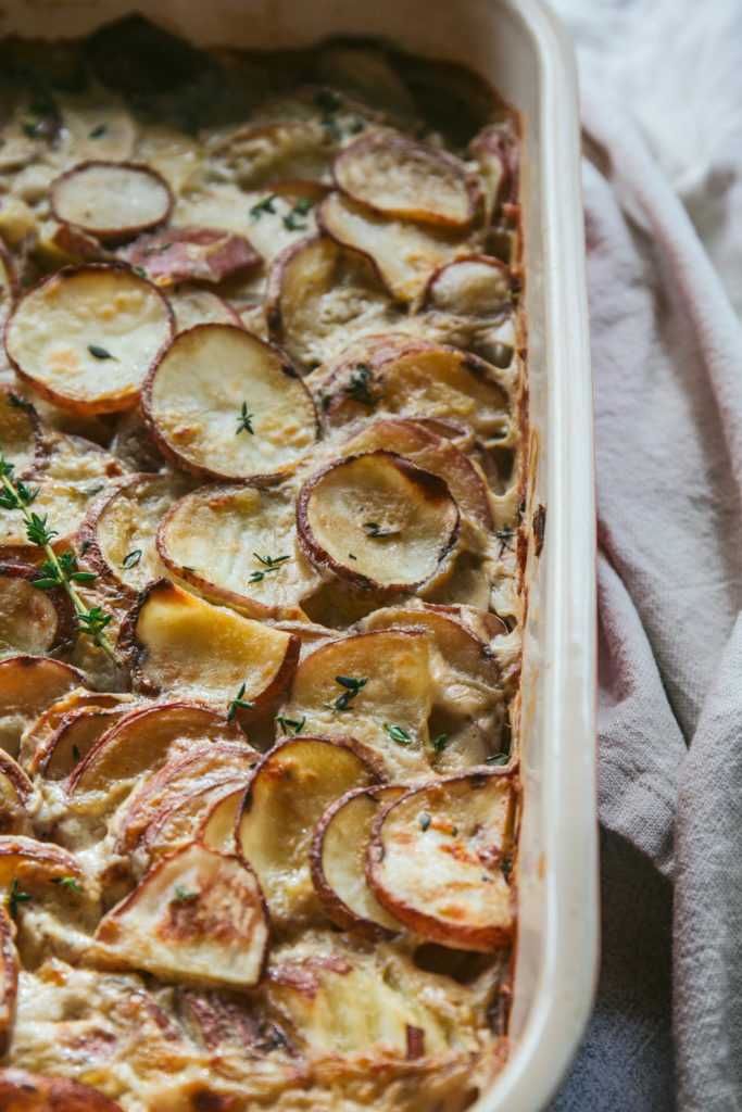 Scalloped potatoes with a napkin and fresh thyme