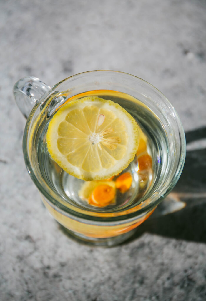 Aerial view of anti-nausea ginger tea with lemon, ginger, and turmeric
