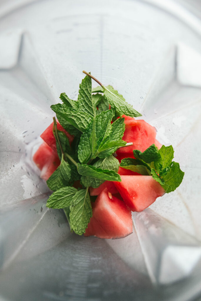 Aerial view of watermelon mint mocktail ingredients in a blender