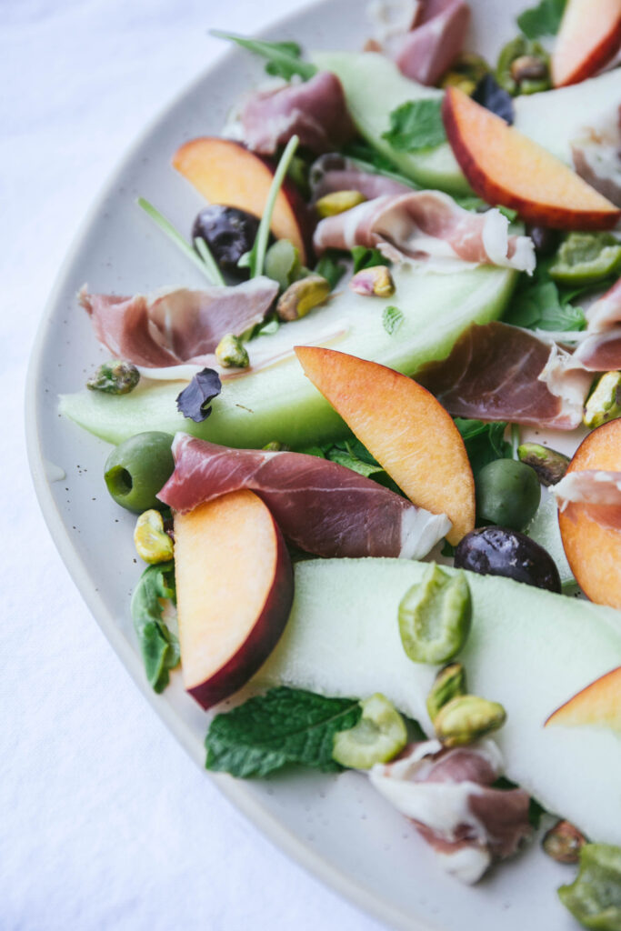 Prosciutto, melon, and herb appetizer with peaches