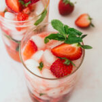 Two strawberry mint mocktails with fresh mint and strawberries