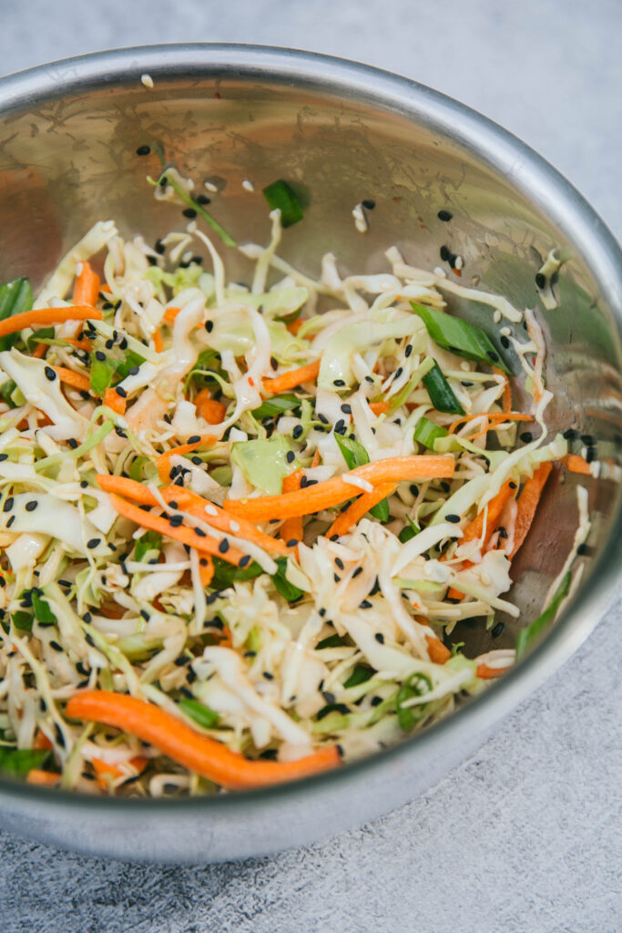 Asian inspired coleslaw in a mixing bowl