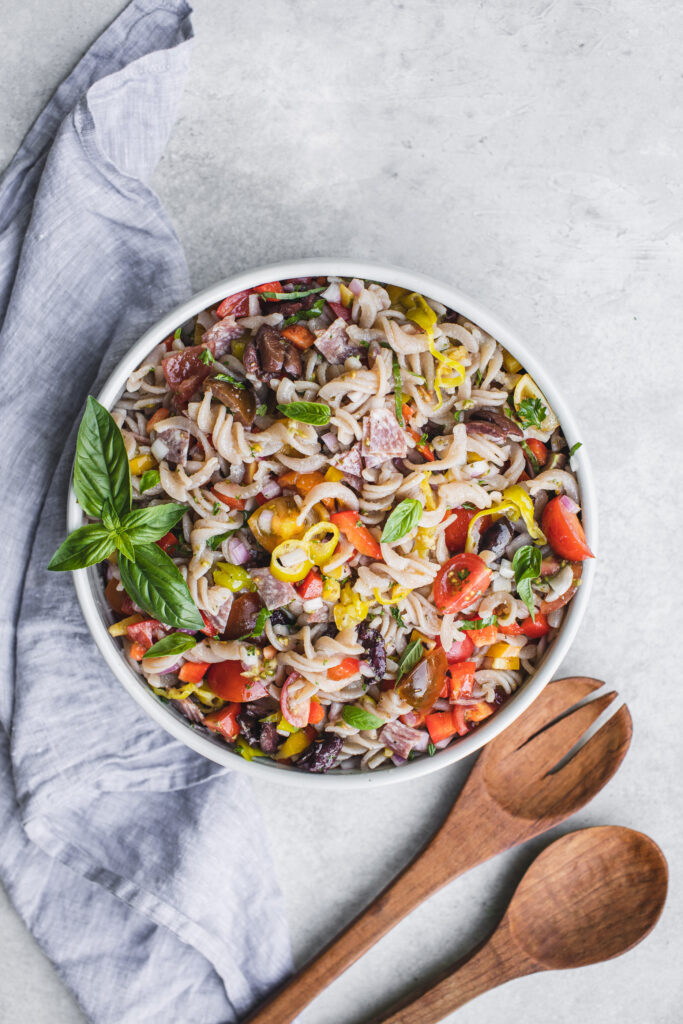Grain-free Italian pasta salad with fresh basil and wooden spoons
