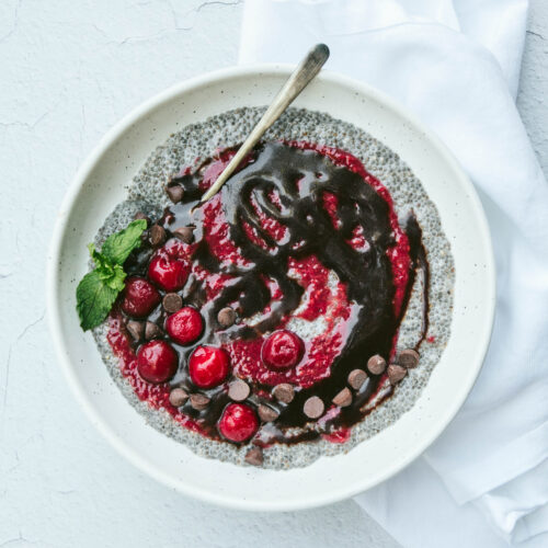 Aerial view of Black Forest Cake chia seed pudding with fresh mint and cherries